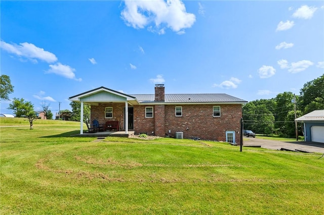 379 Airport Rd, Worthington, PA 16262 - back of property featuring a chimney, brick siding, a yard, and a metal roof