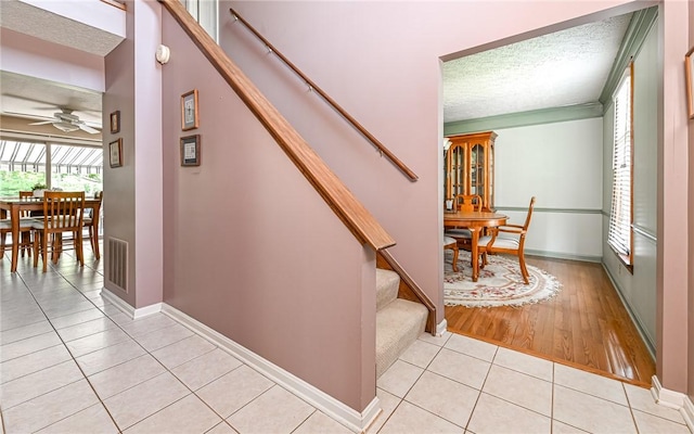 3150 Sundance Ct, Hampton, PA 15101 - staircase featuring a textured ceiling, tile patterned floors, and ceiling fan