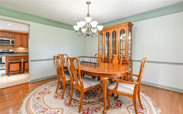 3150 Sundance Ct, Hampton, PA 15101 - dining space featuring a chandelier, light wood finished floors, and a textured ceiling