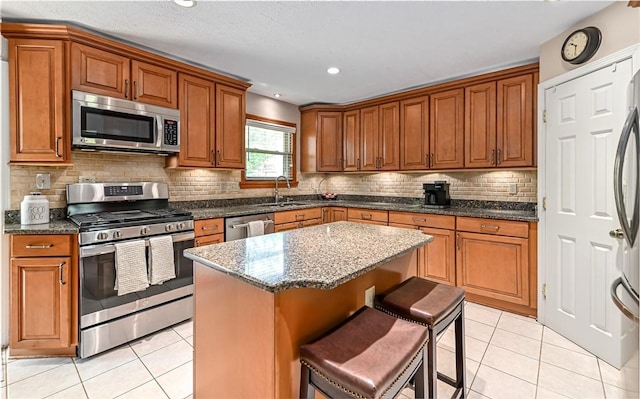3150 Sundance Ct, Hampton, PA 15101 - kitchen with stainless steel appliances, light tile patterned floors, brown cabinets, and recessed lighting