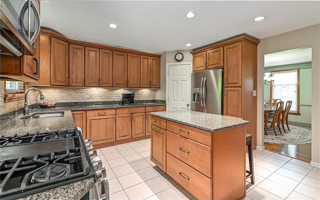 3150 Sundance Ct, Hampton, PA 15101 - kitchen featuring appliances with stainless steel finishes, tasteful backsplash, brown cabinetry, dark stone countertops, and a kitchen island