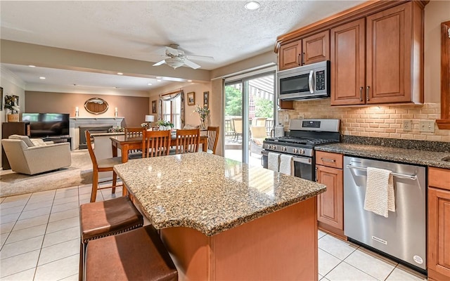 3150 Sundance Ct, Hampton, PA 15101 - kitchen with stainless steel appliances, light tile patterned flooring, ceiling fan, dark stone counters, and recessed lighting