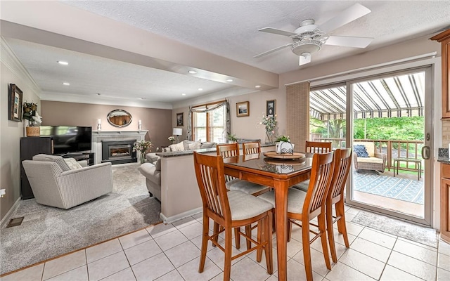3150 Sundance Ct, Hampton, PA 15101 - dining space featuring light tile patterned flooring, ceiling fan, a glass covered fireplace, recessed lighting, and a textured ceiling