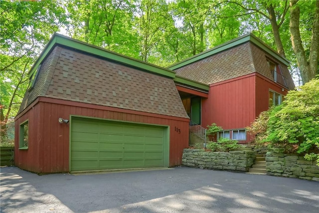 113 S Heide Ln, Peters Twp, PA 15317 - view of front facade featuring a shingled roof, an attached garage, mansard roof, and driveway
