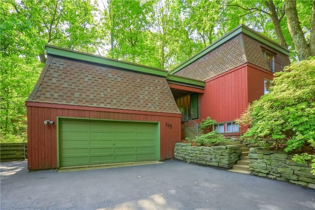 113 S Heide Ln, Peters Twp, PA 15317 - view of front of house featuring roof with shingles, asphalt driveway, and an attached garage