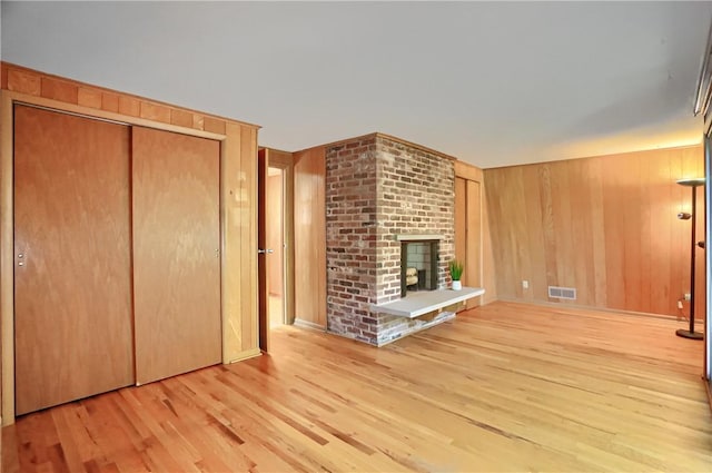 113 S Heide Ln, Peters Twp, PA 15317 - unfurnished living room featuring wood finished floors, a fireplace, and wooden walls