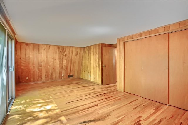 113 S Heide Ln, Peters Twp, PA 15317 - unfurnished bedroom with wood finished floors, a closet, and wood walls