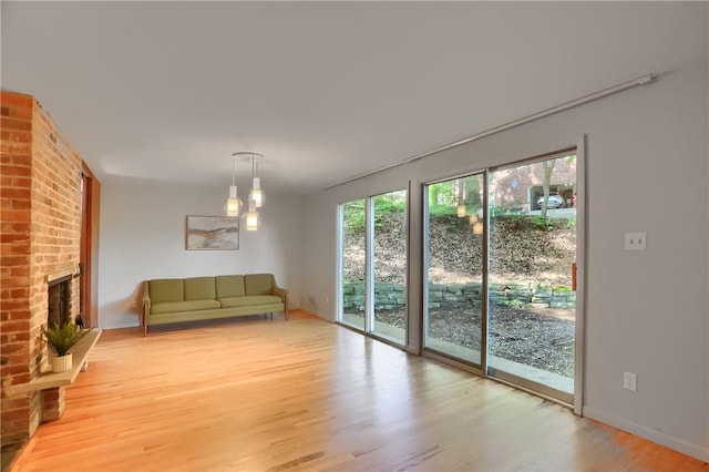 113 S Heide Ln, Peters Twp, PA 15317 - unfurnished living room with light wood-type flooring and a fireplace