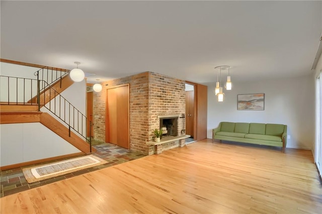 113 S Heide Ln, Peters Twp, PA 15317 - living area with wood finished floors, stairway, and a brick fireplace