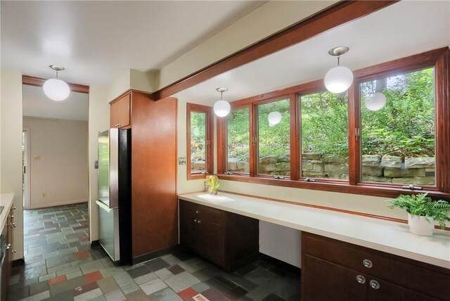 113 S Heide Ln, Peters Twp, PA 15317 - kitchen with freestanding refrigerator, light countertops, stone finish floors, and pendant lighting