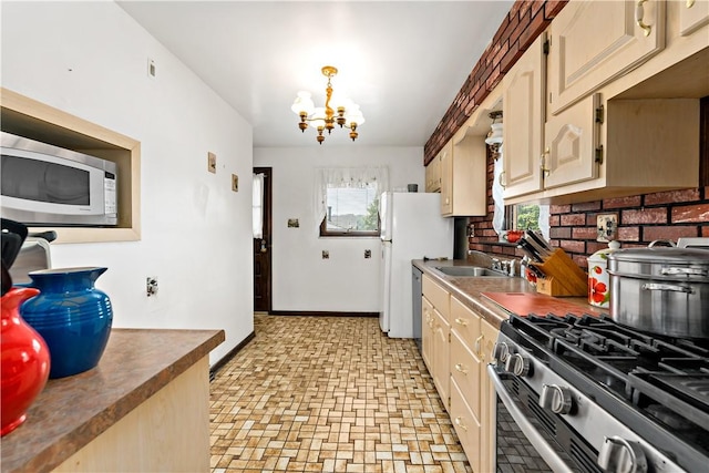 463 Thomas St, Monroeville, PA 15146 - kitchen featuring stainless steel appliances, a chandelier, and brick patterned flooring