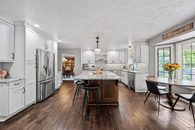 204 Pine Cone Ct, Pine Twp Nal, PA 15090 - kitchen featuring appliances with stainless steel finishes, a kitchen island, dark wood-style floors, white cabinetry, and light stone counters