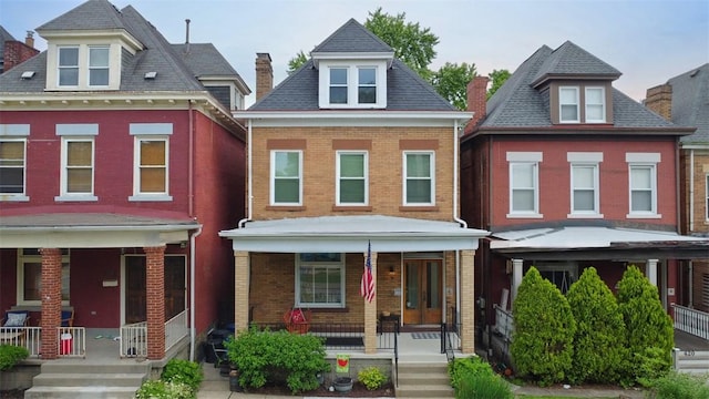 422 S Lang Ave, Point Breeze, PA 15208 - view of front of property featuring a porch, brick siding, and a chimney