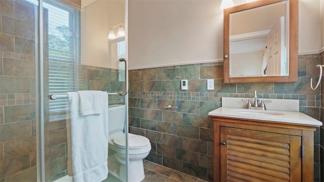 422 S Lang Ave, Point Breeze, PA 15208 - bathroom featuring tile walls, vanity, a shower stall, and wainscoting
