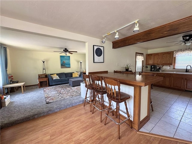 326 Aiken Rd, Shenango Twp Law, PA 16101 - kitchen featuring ceiling fan, a breakfast bar area, open floor plan, and a peninsula