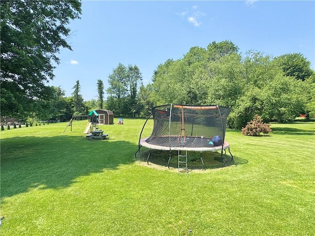 326 Aiken Rd, Shenango Twp Law, PA 16101 - view of grassy yard featuring a trampoline, a playground, a storage unit, and view of wooded area