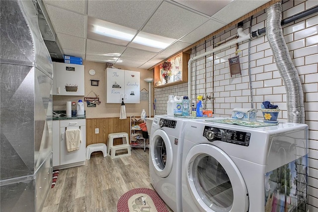 354 Moween Rd, Loyalhanna, PA 15681 - laundry area with washer and dryer, light wood-style flooring, and a wainscoted wall