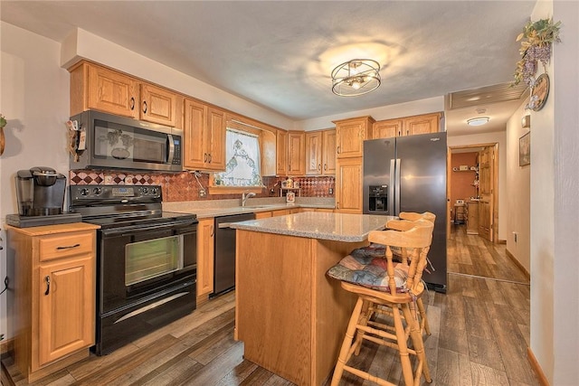 354 Moween Rd, Loyalhanna, PA 15681 - kitchen featuring stainless steel appliances, dark wood finished floors, backsplash, a center island, and a breakfast bar area