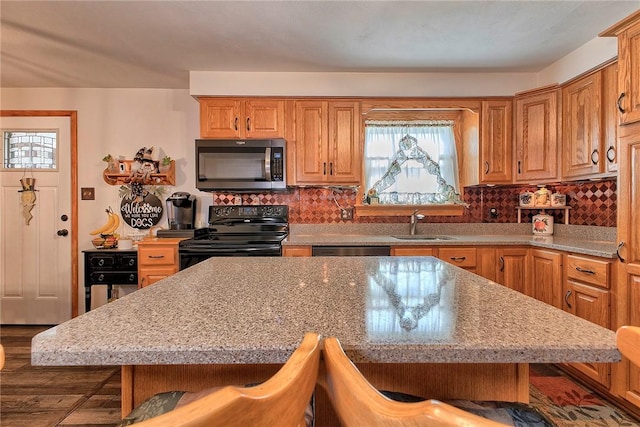 354 Moween Rd, Loyalhanna, PA 15681 - kitchen featuring black / electric stove, a breakfast bar, and backsplash