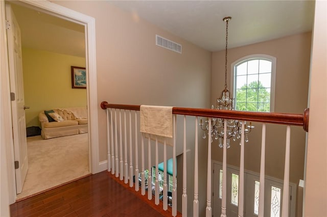 1010 Country Club Rd, Penn Twp Wml, PA 15644 - corridor featuring wood finished floors, a chandelier, and an upstairs landing