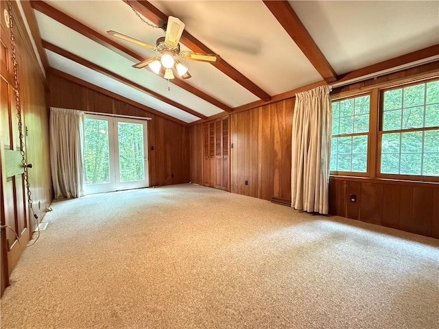 301 Hopper Rd, Delaware Twp, PA 16154 - carpeted empty room with wood walls and a ceiling fan