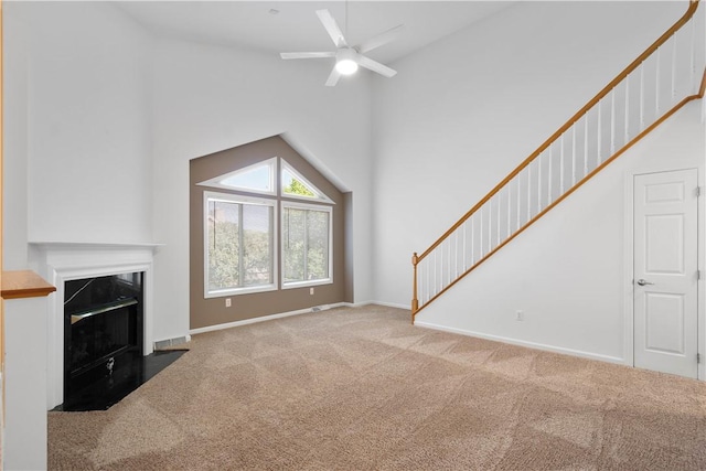 9404 Sundance Dr, South Fayette, PA 15017 - unfurnished living room featuring carpet flooring, high vaulted ceiling, a ceiling fan, and a fireplace with flush hearth