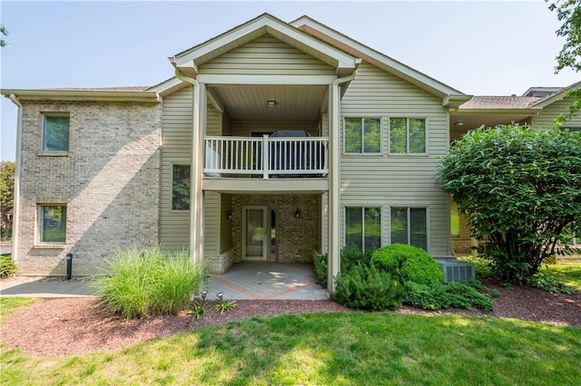 9404 Sundance Dr, South Fayette, PA 15017 - rear view of house with a balcony, brick siding, and a yard