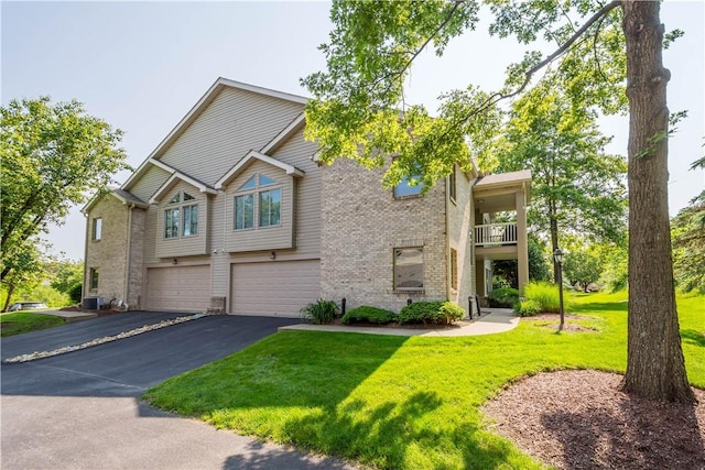 9404 Sundance Dr, South Fayette, PA 15017 - view of property with an attached garage, driveway, brick siding, and a front yard