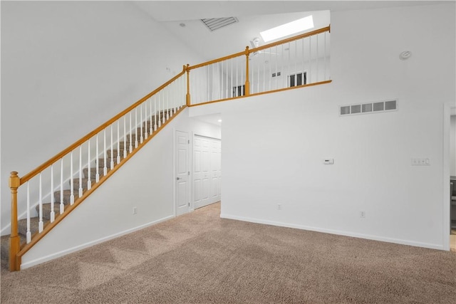 9404 Sundance Dr, South Fayette, PA 15017 - stairway featuring a high ceiling, carpet, and a skylight