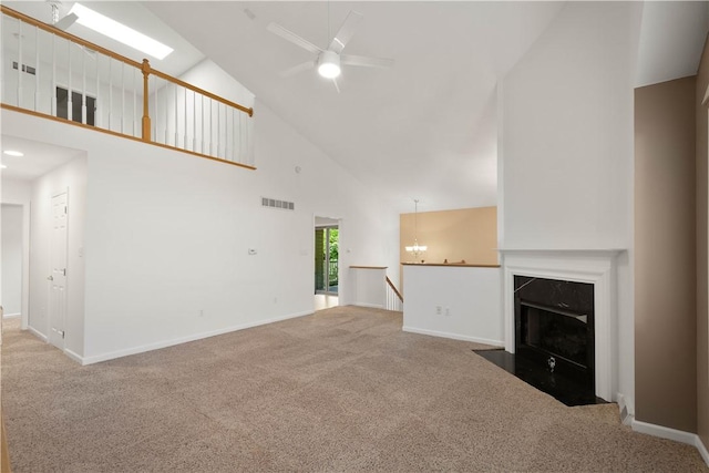 9404 Sundance Dr, South Fayette, PA 15017 - unfurnished living room with high vaulted ceiling, carpet flooring, a ceiling fan, a chandelier, and a fireplace with flush hearth
