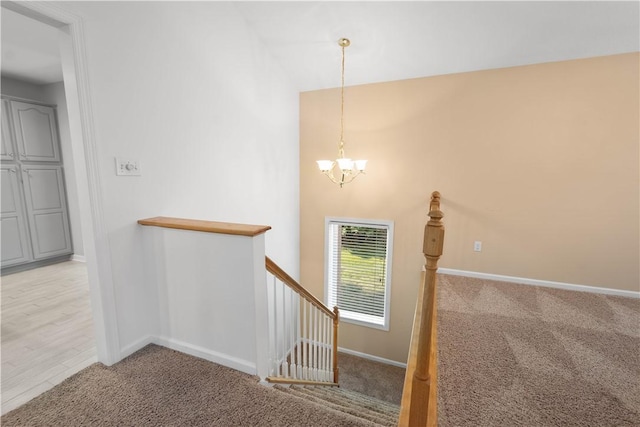 9404 Sundance Dr, South Fayette, PA 15017 - staircase with a chandelier, carpet floors, and lofted ceiling