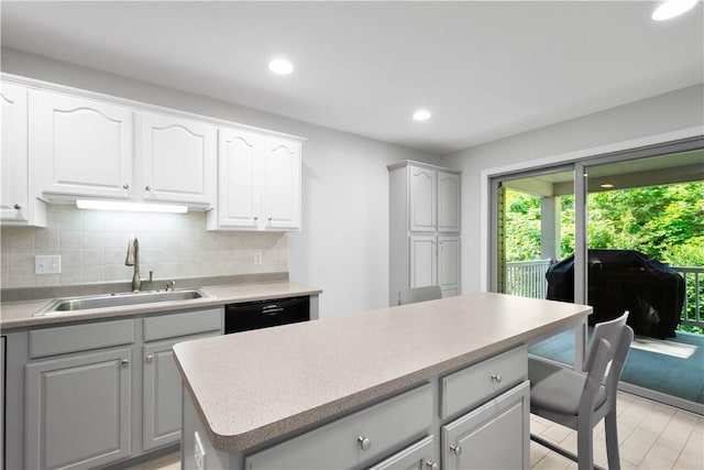 9404 Sundance Dr, South Fayette, PA 15017 - kitchen with decorative backsplash, dishwasher, recessed lighting, a kitchen island, and light countertops