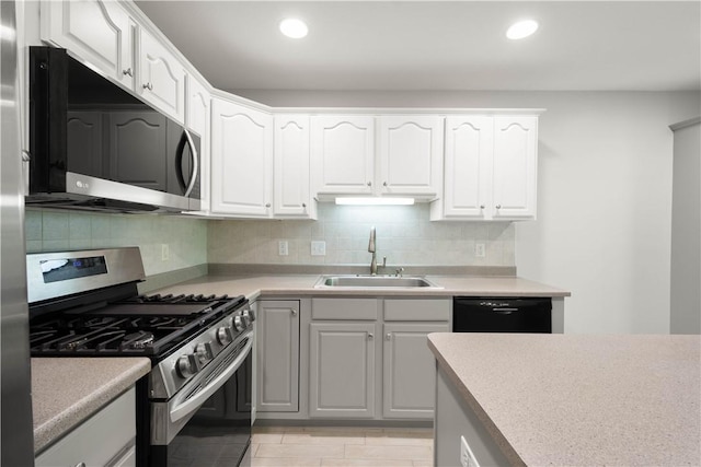 9404 Sundance Dr, South Fayette, PA 15017 - kitchen with stainless steel appliances, tasteful backsplash, white cabinetry, light countertops, and recessed lighting