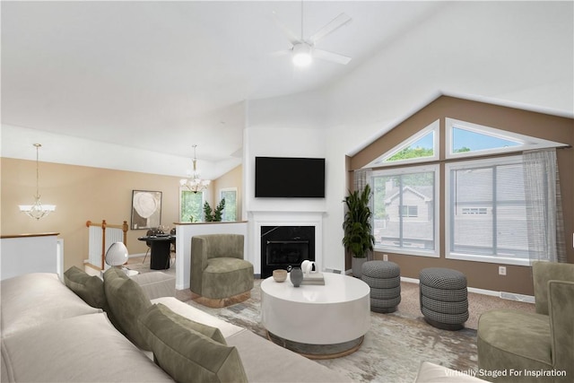 9404 Sundance Dr, South Fayette, PA 15017 - living area featuring a chandelier, vaulted ceiling, healthy amount of natural light, a ceiling fan, and a premium fireplace
