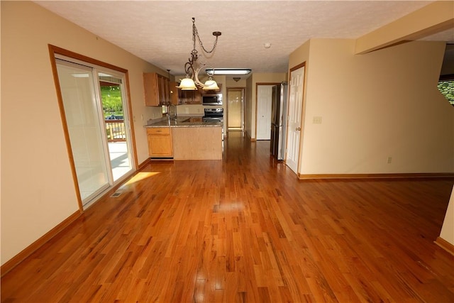 158 Snowdrift Rd, Nottingham, PA 15330 - kitchen featuring stainless steel appliances, a peninsula, open floor plan, dark wood-style floors, and a textured ceiling