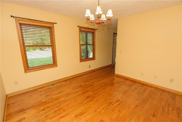 158 Snowdrift Rd, Nottingham, PA 15330 - spare room with a chandelier, light wood finished floors, and a textured ceiling