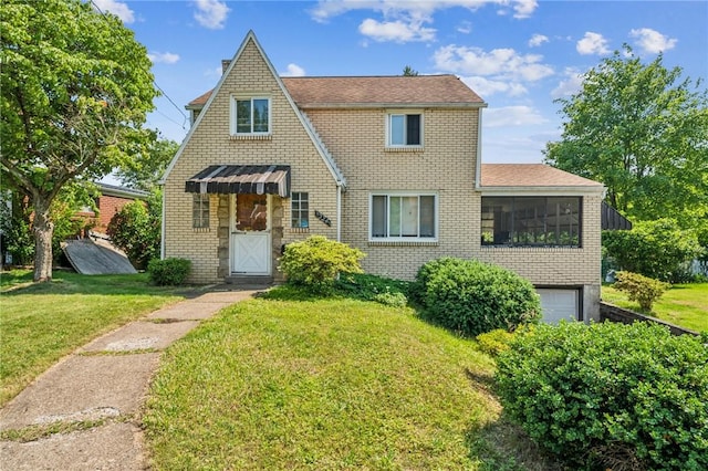 1324 Maple Ave, Verona, PA 15147 - tudor home with brick siding, a front lawn, and an attached garage