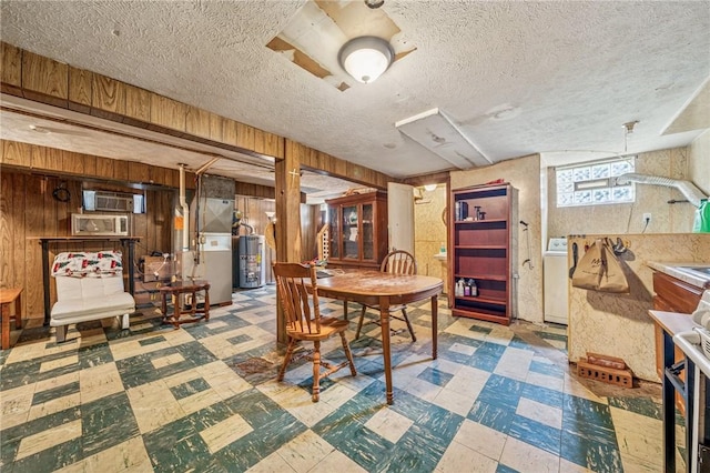 1324 Maple Ave, Verona, PA 15147 - dining room featuring tile patterned floors, water heater, wood walls, heating unit, and a textured ceiling