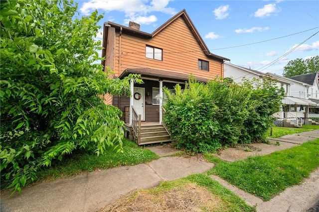 318 3rd Ave, Ford City Boro, PA 16226 - view of front of property with a chimney and covered porch