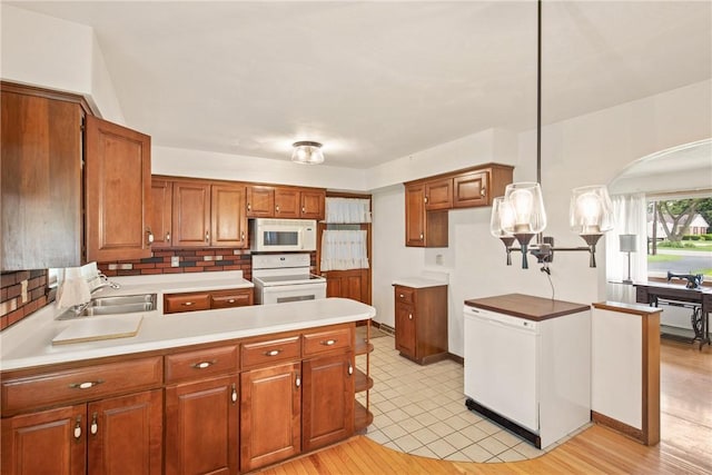 2345 Stoystown Rd, Somerset Twp, PA 15541 - kitchen featuring white appliances, brown cabinets, a peninsula, and light countertops