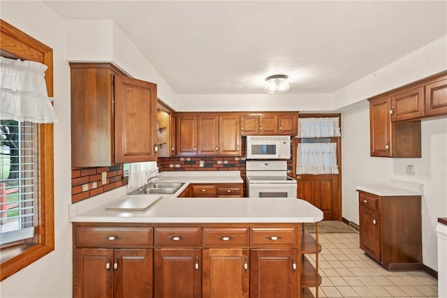 2345 Stoystown Rd, Somerset Twp, PA 15541 - kitchen with white appliances, light countertops, brown cabinets, and a peninsula