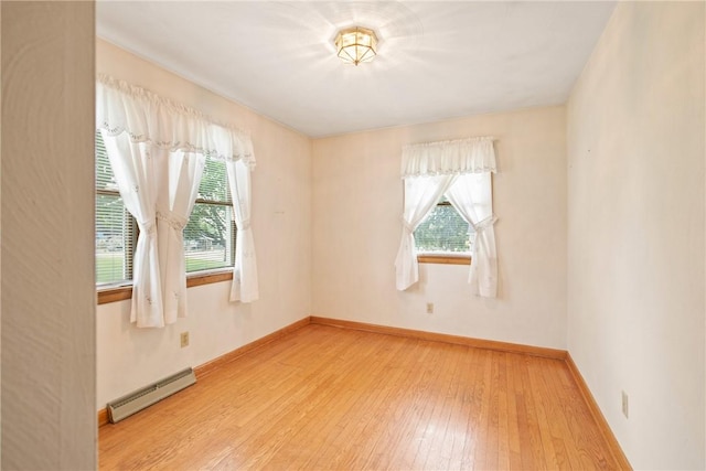 2345 Stoystown Rd, Somerset Twp, PA 15541 - unfurnished room featuring a baseboard heating unit, plenty of natural light, and light wood-style flooring