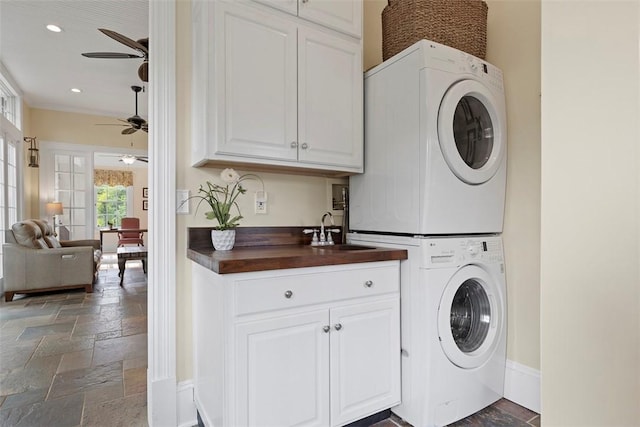 899 Old Thorn Run Rd, Moon/Crescent Twp, PA 15108 - laundry area featuring cabinet space, a ceiling fan, stone tile floors, stacked washer and clothes dryer, and recessed lighting