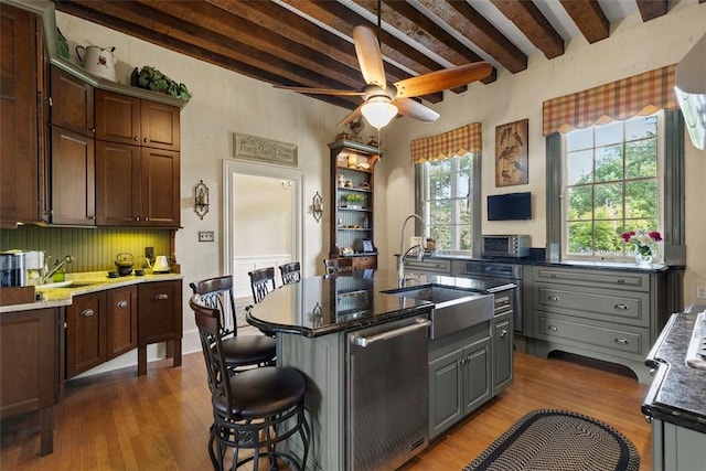 899 Old Thorn Run Rd, Moon/Crescent Twp, PA 15108 - kitchen featuring stainless steel dishwasher, wood finished floors, beamed ceiling, a ceiling fan, and a breakfast bar