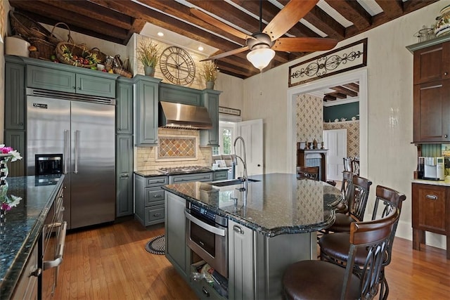 899 Old Thorn Run Rd, Moon/Crescent Twp, PA 15108 - kitchen featuring stainless steel appliances, ventilation hood, a ceiling fan, hardwood / wood-style flooring, and beam ceiling