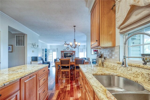 400 Chapel, Cranberry Twp, PA 16066 - kitchen featuring a chandelier, wood finished floors, ornamental molding, light stone counters, and open floor plan