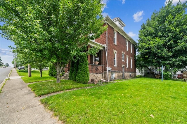 520 Morrell Ave, Connellsville, PA 15425 - view of home's exterior featuring brick siding, a lawn, covered porch, and stairs
