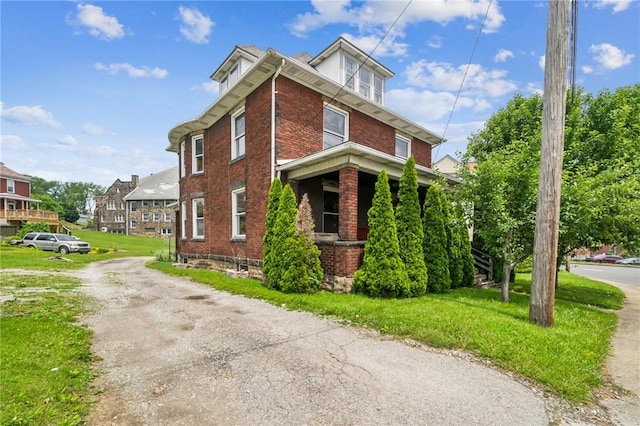 520 Morrell Ave, Connellsville, PA 15425 - view of side of home with brick siding, driveway, and a lawn