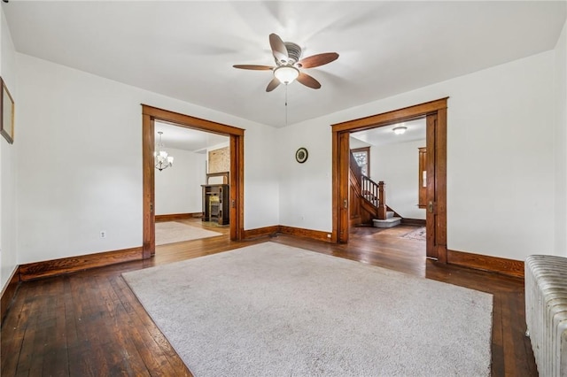 520 Morrell Ave, Connellsville, PA 15425 - unfurnished room with radiator heating unit, dark wood finished floors, stairs, and a ceiling fan