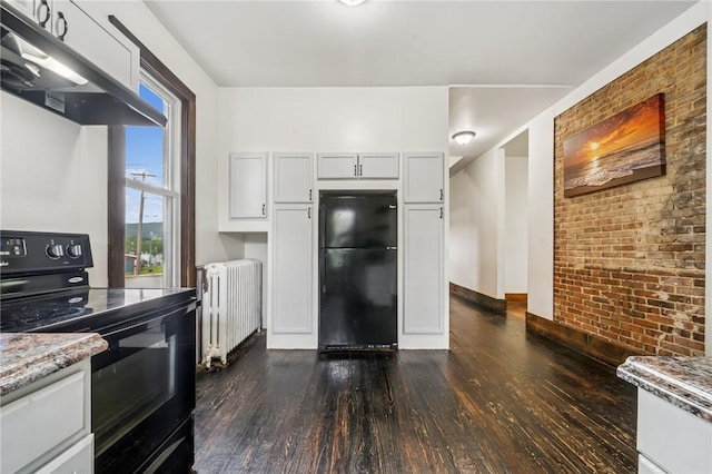520 Morrell Ave, Connellsville, PA 15425 - kitchen with radiator, black appliances, extractor fan, dark wood-style floors, and brick wall